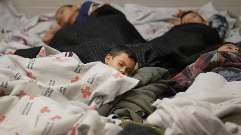 Detainees sleep in a holding cell at a U.S. Customs and Border Protection processing facility, in Brownsville